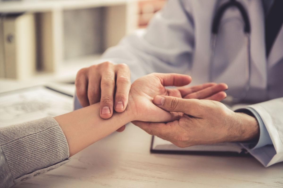 Rheumatology Consultation in Akola Doctor examining patient's hand for arthritis symptoms